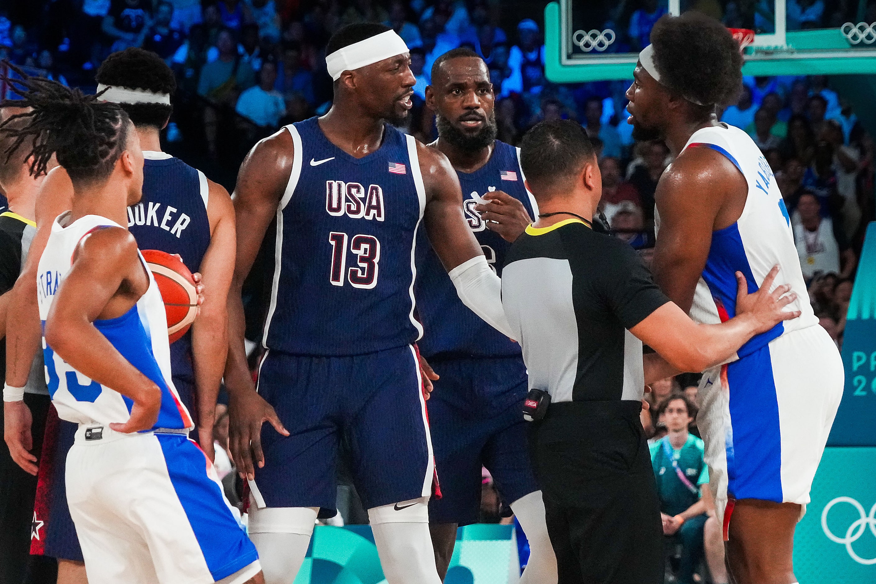 Officials step in to separate Bam Adebayo (13) of the United States and Guerschon Yabusele...