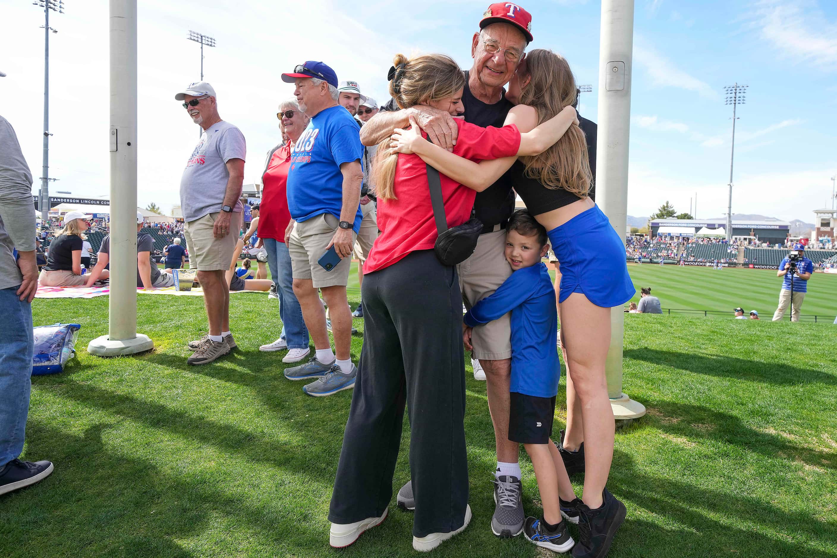 Cal Kost is hugged by Lindsey Doss (left) her son Max Doss, 4, and Jessica Zura (right)...