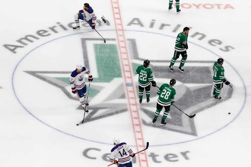 Dallas Stars and Edmonton Oilers players warm up before Game 2 of the NHL hockey Stanley Cup...