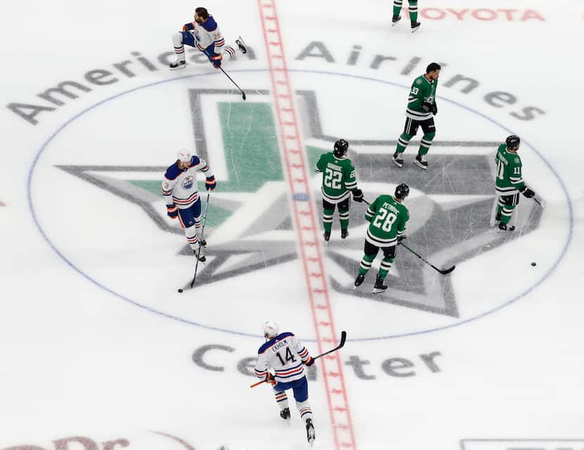 Dallas Stars and Edmonton Oilers players warm up before Game 2 of the NHL hockey Stanley Cup...