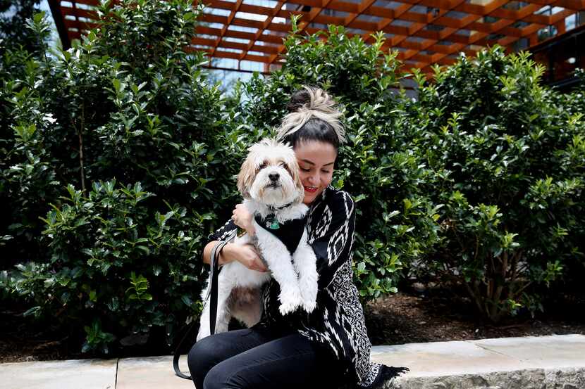 Missy Monoxide, her artist name, sits for a photograph with her dog Armani along Main Street...