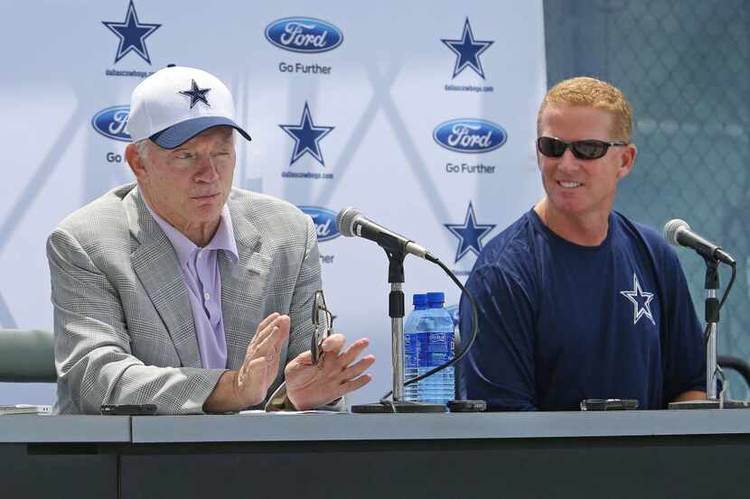 Dallas Cowboys owner Jerry Jones, left, speaks as head coach Jason Garrett listens during...