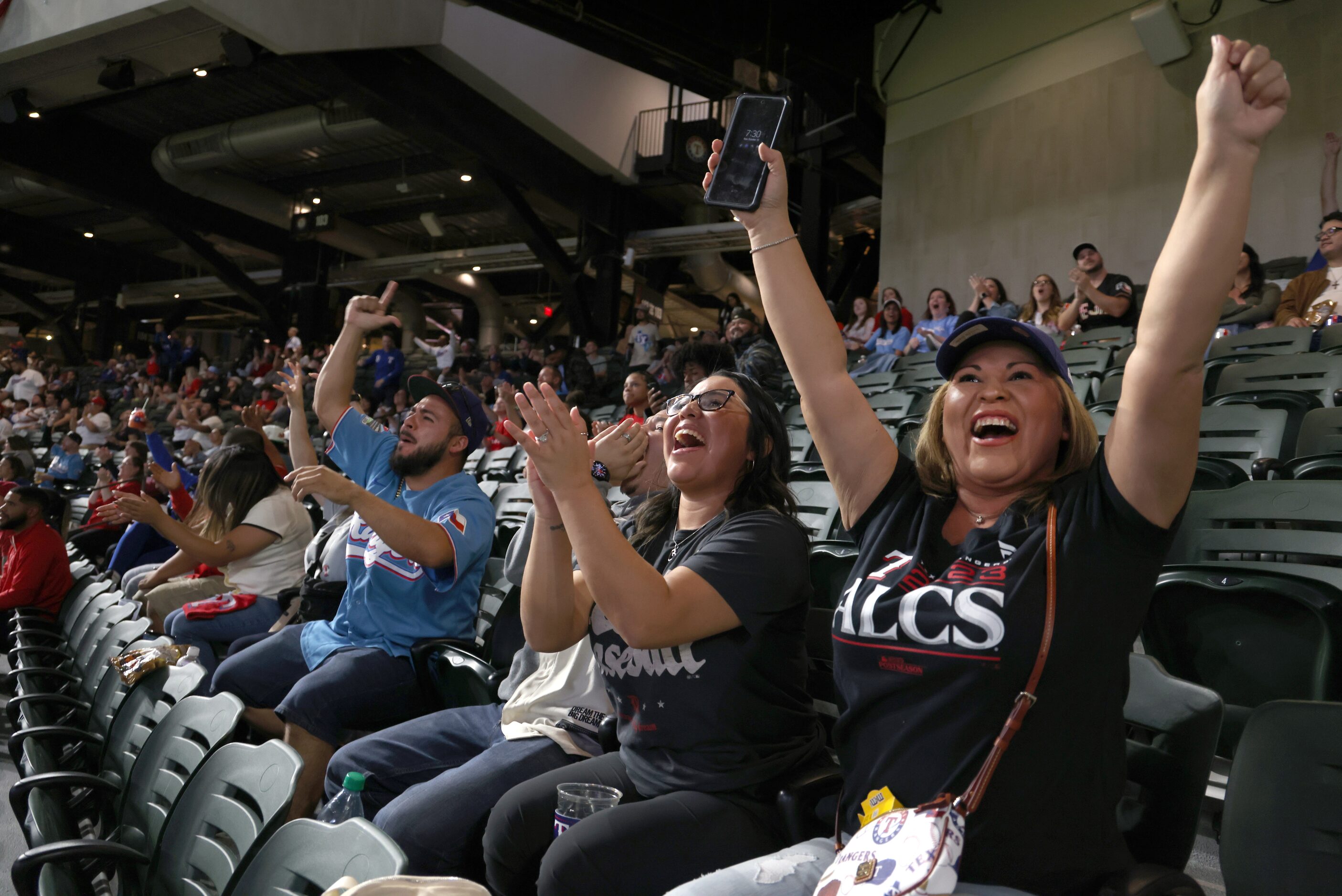 Texas Rangers fans react after Evan Carter reached base safely in the top of the second...