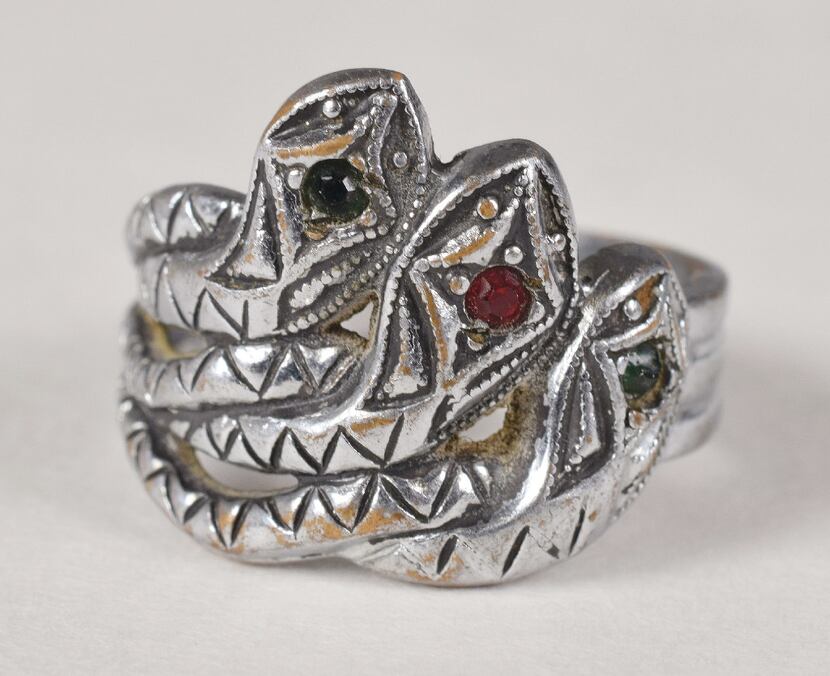 Bonnie Parker's silver-toned three-headed snake ring featuring green and red jewels was sold...