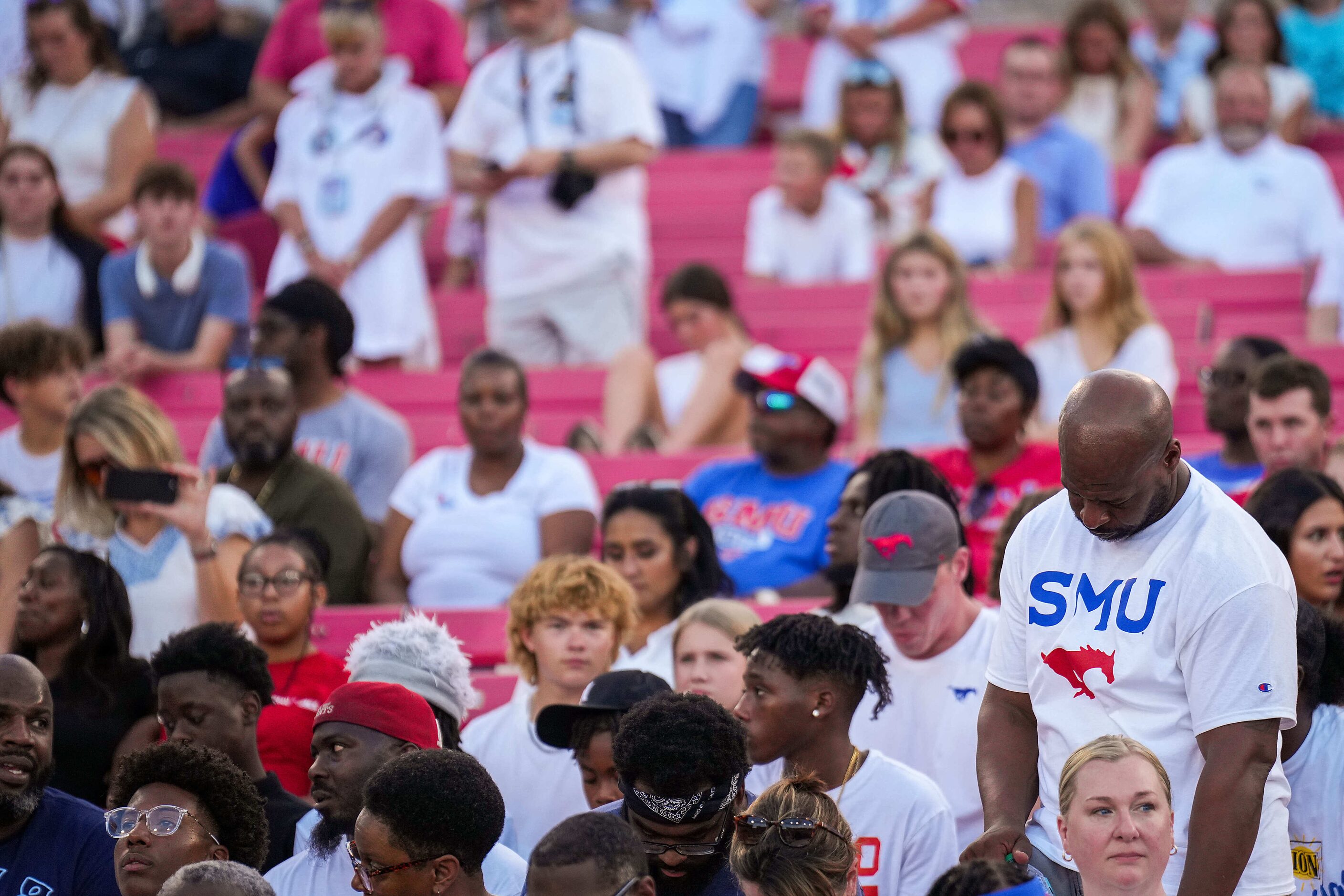 Fans observe a moment of silence for slain Dallas police officer Darron Burks before an NCAA...