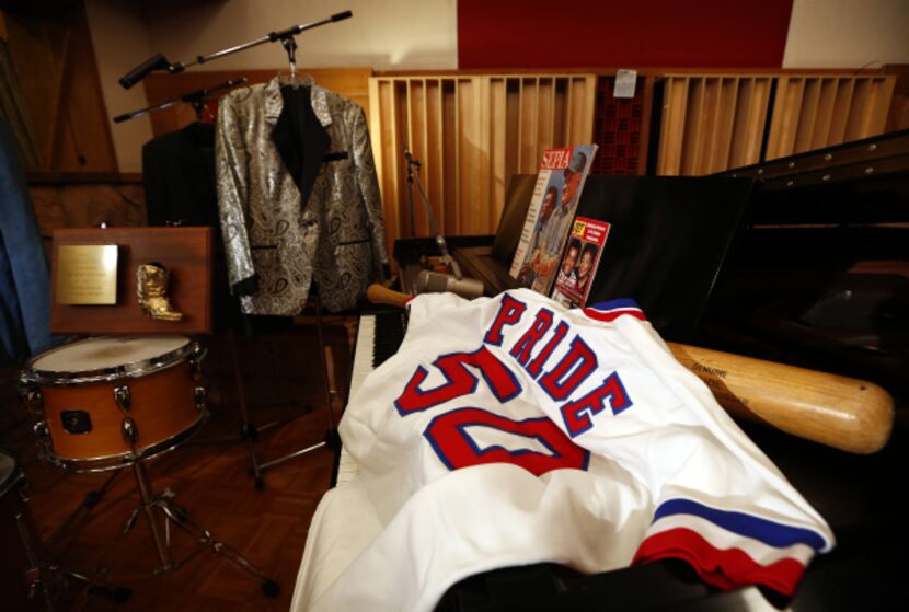 Country star Charley Pride's Texas Rangers jersey and baseball bat are part of his...