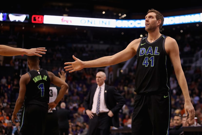 PHOENIX, AZ - JANUARY 31:  Dirk Nowitzki #41 of the Dallas Mavericks high fives teammates...