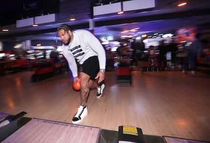 Cowboys offensive lineman La'el Collins bowls during a charity bowling event at Bowlero in...