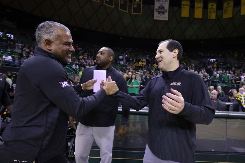 Kansas State head coach Jerome Tang, left, shakes hands with Baylor head coach Scott Drew...