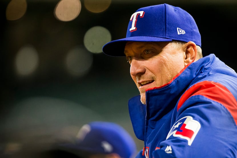 Texas Rangers manager Jeff Banister watches his team from the dugout during the third inning...