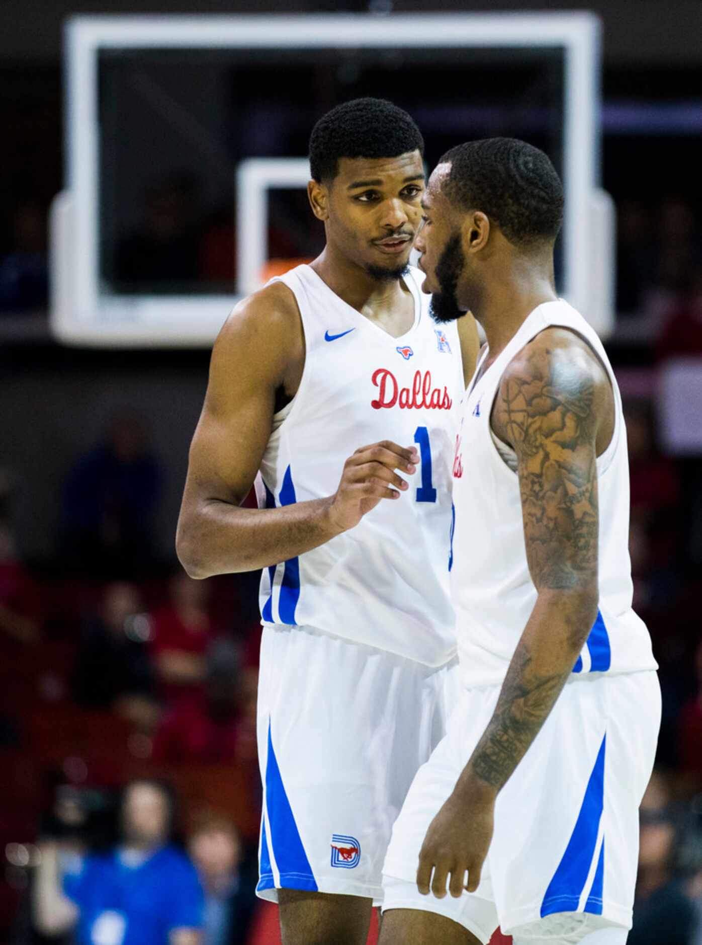 Southern Methodist Mustangs forward Feron Hunt (1) talks with guard Tyson Jolly (0) during...