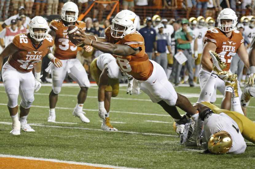 FILE - Texas quarterback Tyrone Swoopes (18) scores the winning touchdown in the second...
