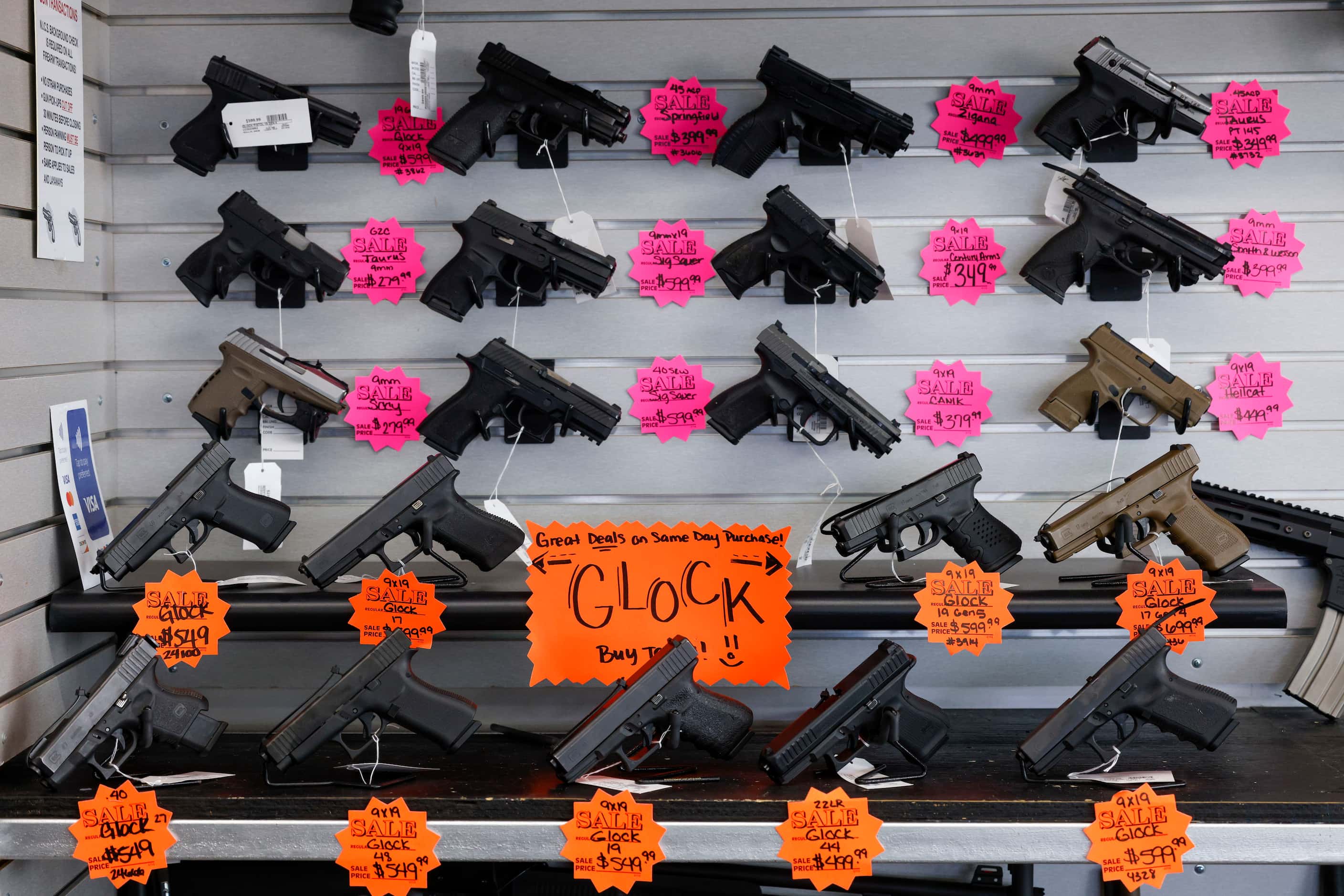 Various handguns sit for sale at Uncle Dan’s Pawn Shop in Mesquite, Texas, Tuesday, Aug. 16,...