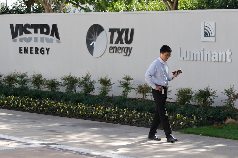 Jeff Yang, a contractor for Vistra Energy, talks on his phone at the entrance to the...