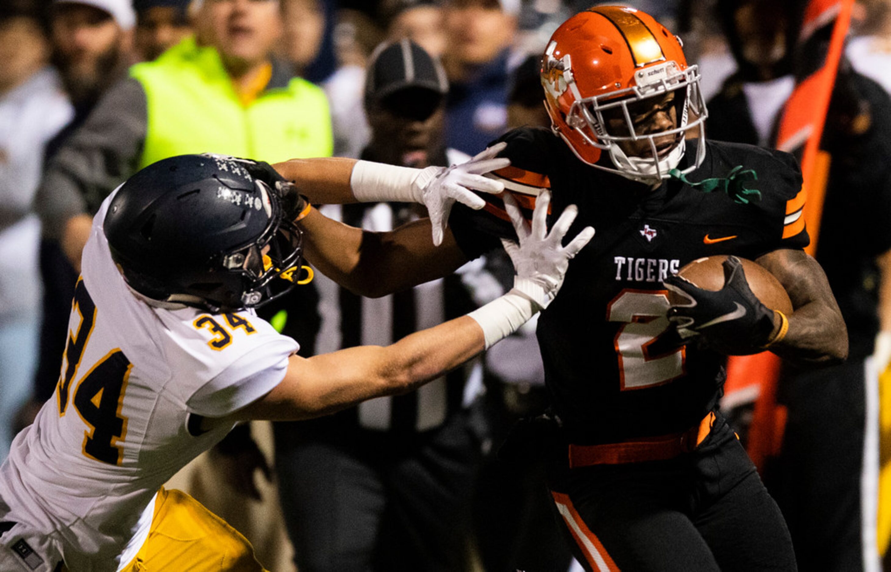 Highland Park's Sam Sessions (34) pushes Lancaster running back Tre Bradford (2) out of...