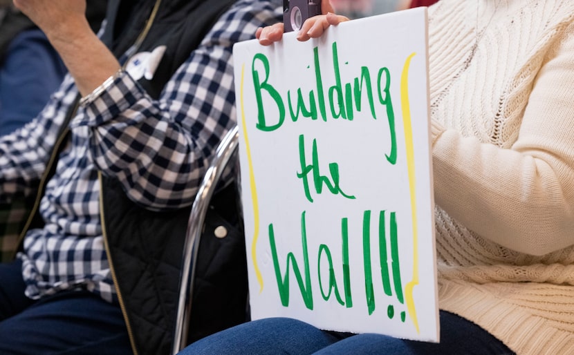 A supporter of Gov. Greg Abbott held a sign during a Get Out The Vote event at Ben Franklin...