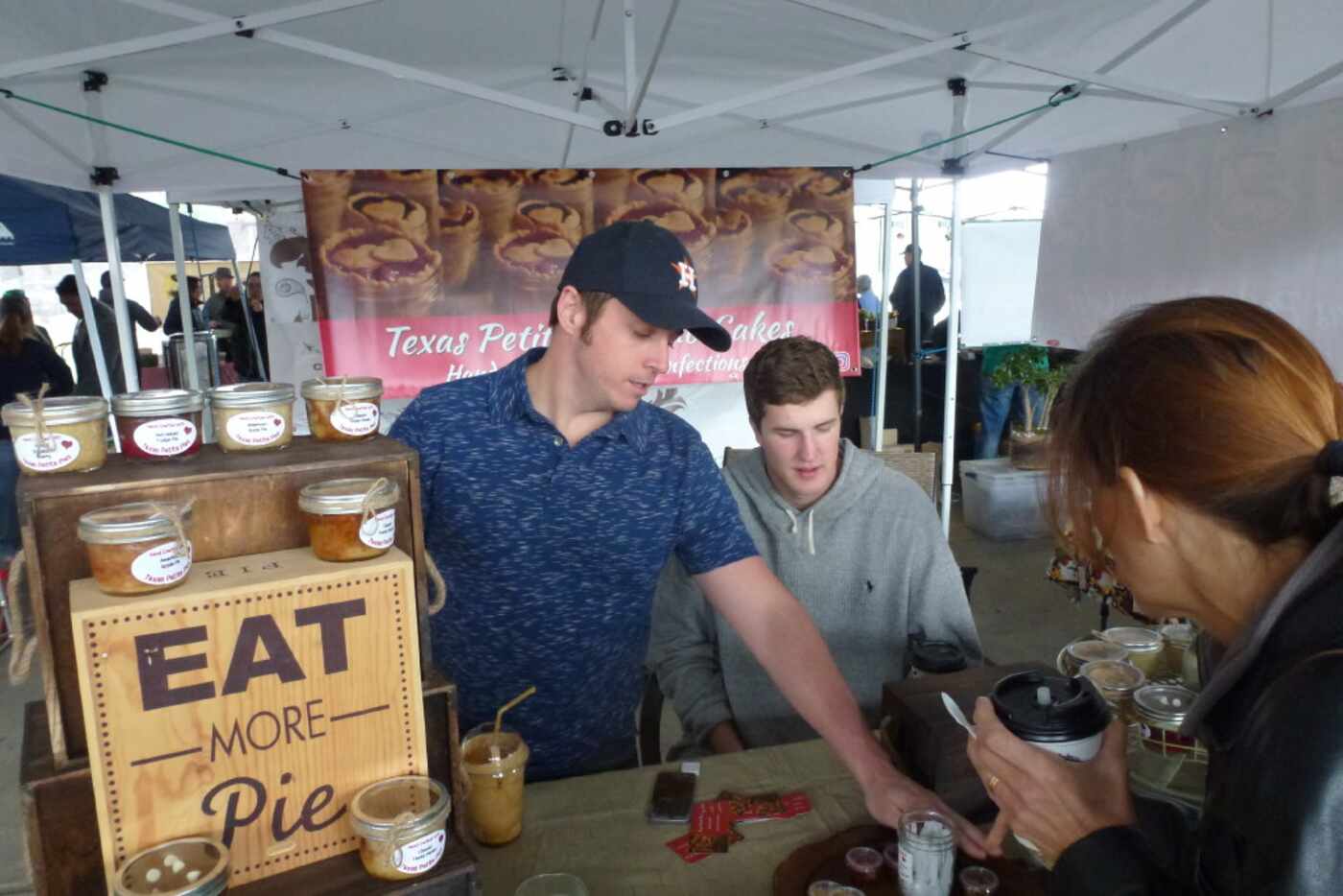 Robert Granberry shows a customer at the Dallas Farmers Market what s in the samples for...