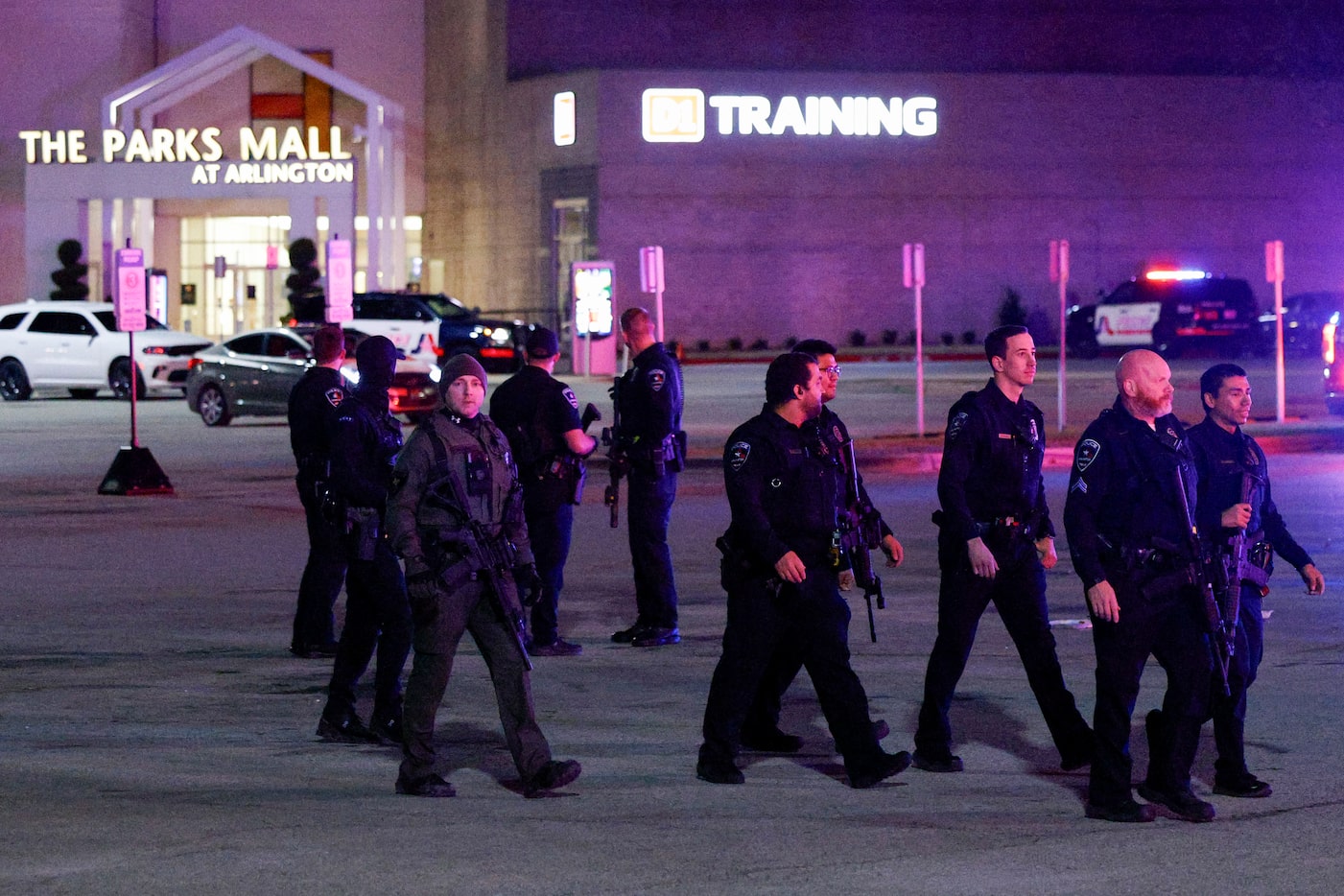 Arlington police officers work the scene after two people were wounded in a shooting at The...