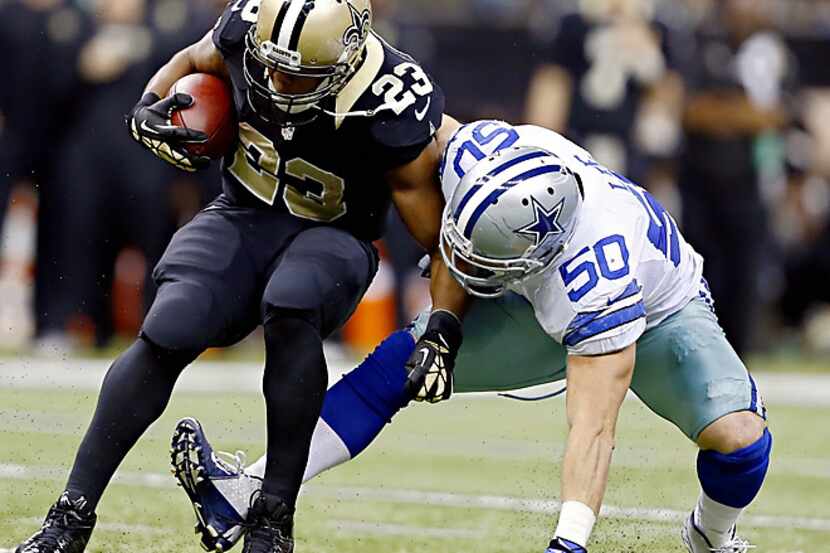 Dallas Cowboys middle linebacker Sean Lee (50) tackles New Orleans Saints running back...