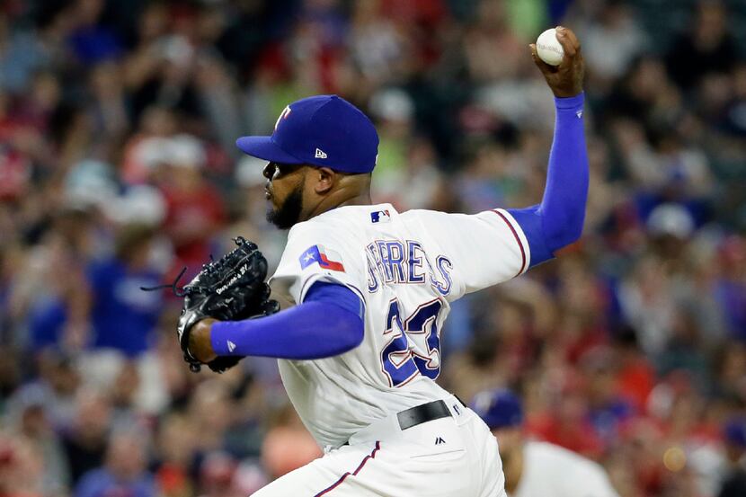 Texas Rangers relief pitcher Jeremy Jeffress throws to the Los Angeles Angels in the eighth...