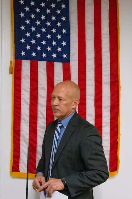 Newly elected District Attorney John Creuzot walks away after his swearing-in ceremony in...
