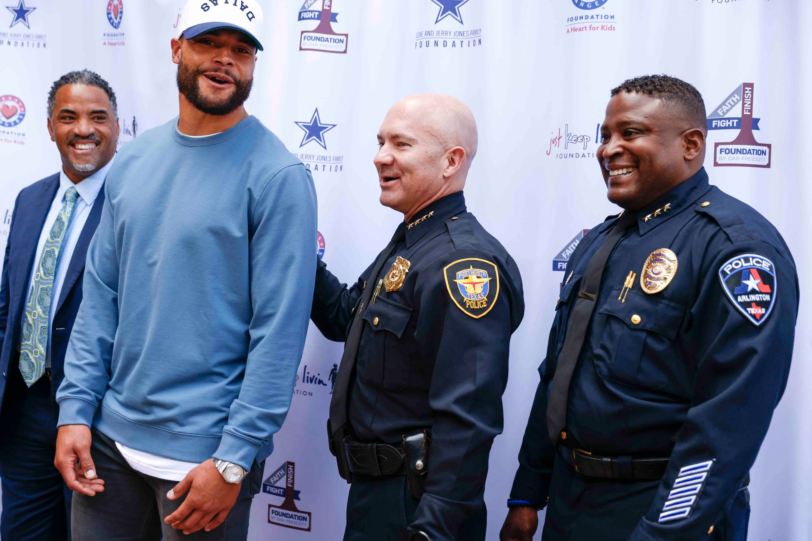 Fort Worth Police Chief Chief Noakes, second from right, talks to founder of Faith Fight...