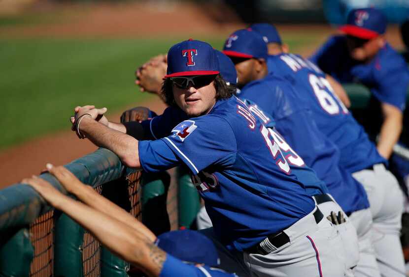 Texas Rangers pitcher Luke Jackson stands in the dugout during a Major League Baseball...