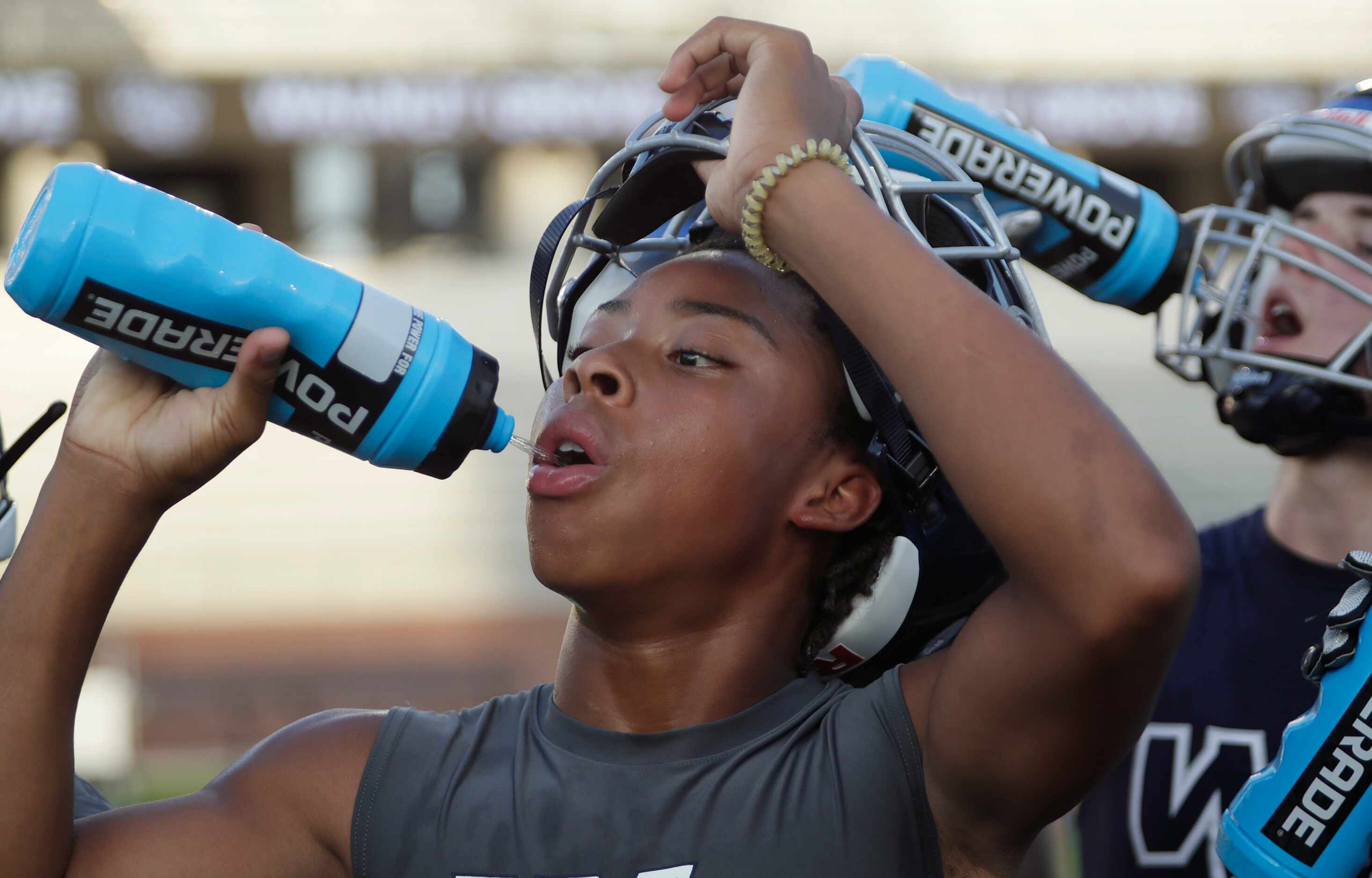 Running back Nolon Buckels, 15, takes a drink during the first water break as Walnut Grove...