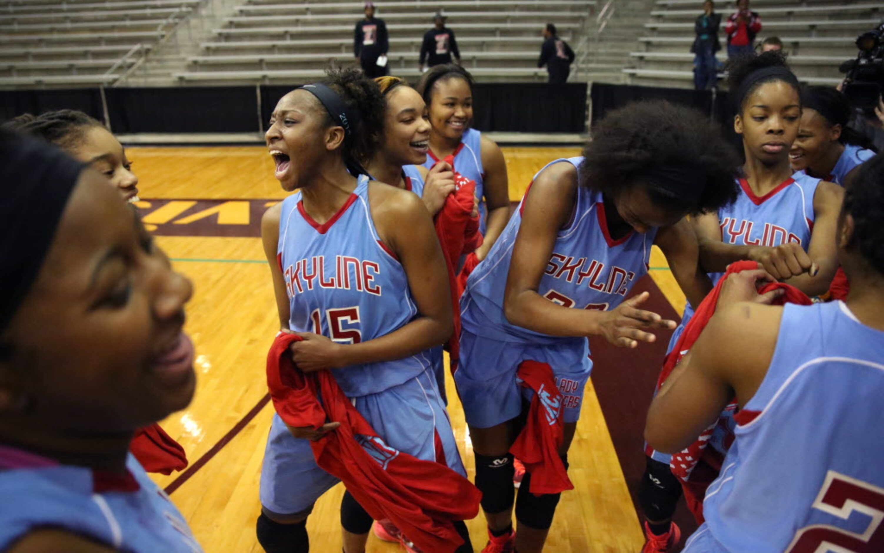 Skyline forward Jordan Alexander screams (15) with teammates as they celebrate their region...