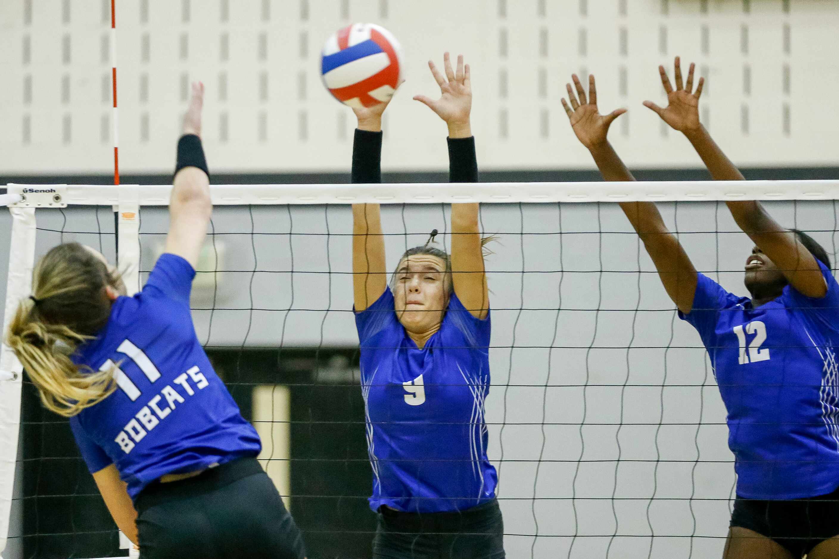 Trophy Club Byron Nelson outside hitter Morgan Inemer (11) hits the ball into the block of...