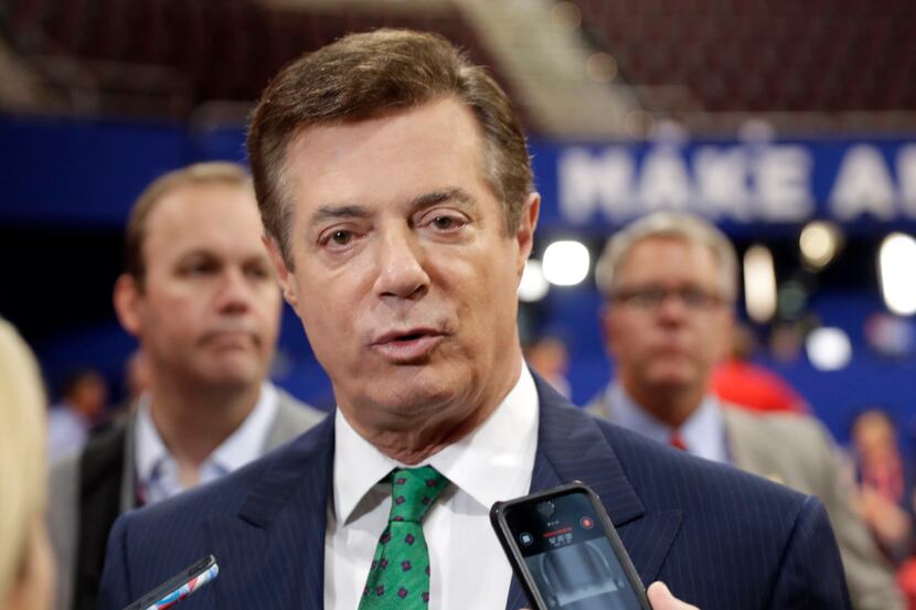 Donald Trump campaign chairman Paul Manafort talks to reporters in July 2016 on the floor of...