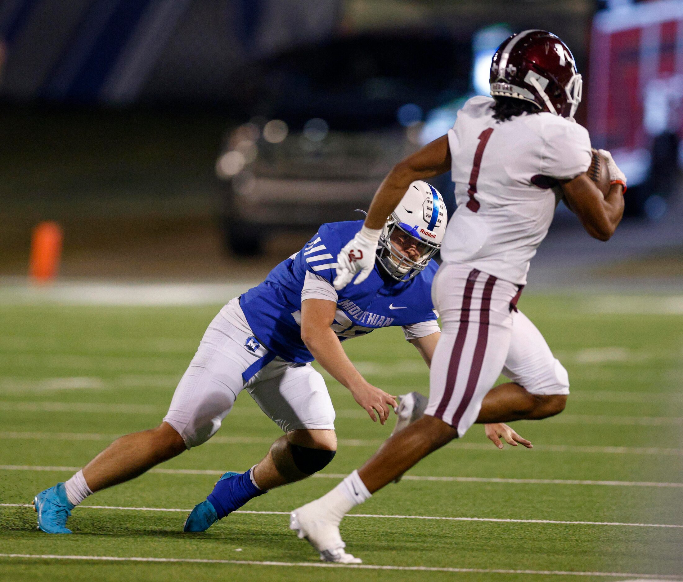 Midlothian kicker Tyson Williams (26) fails to tackle Red Oak defensive back Warren Roberson...