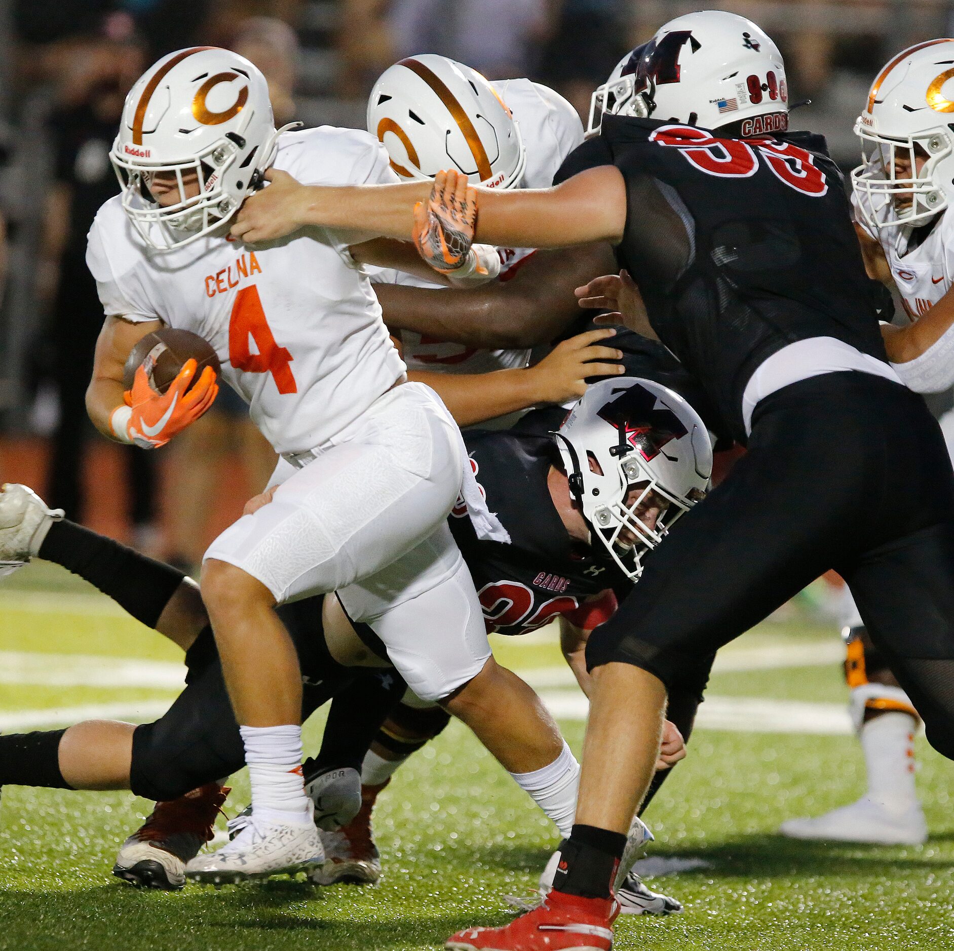 Celina High School running back Will Taylo (4) runs out of the grasp of Melissa High School...