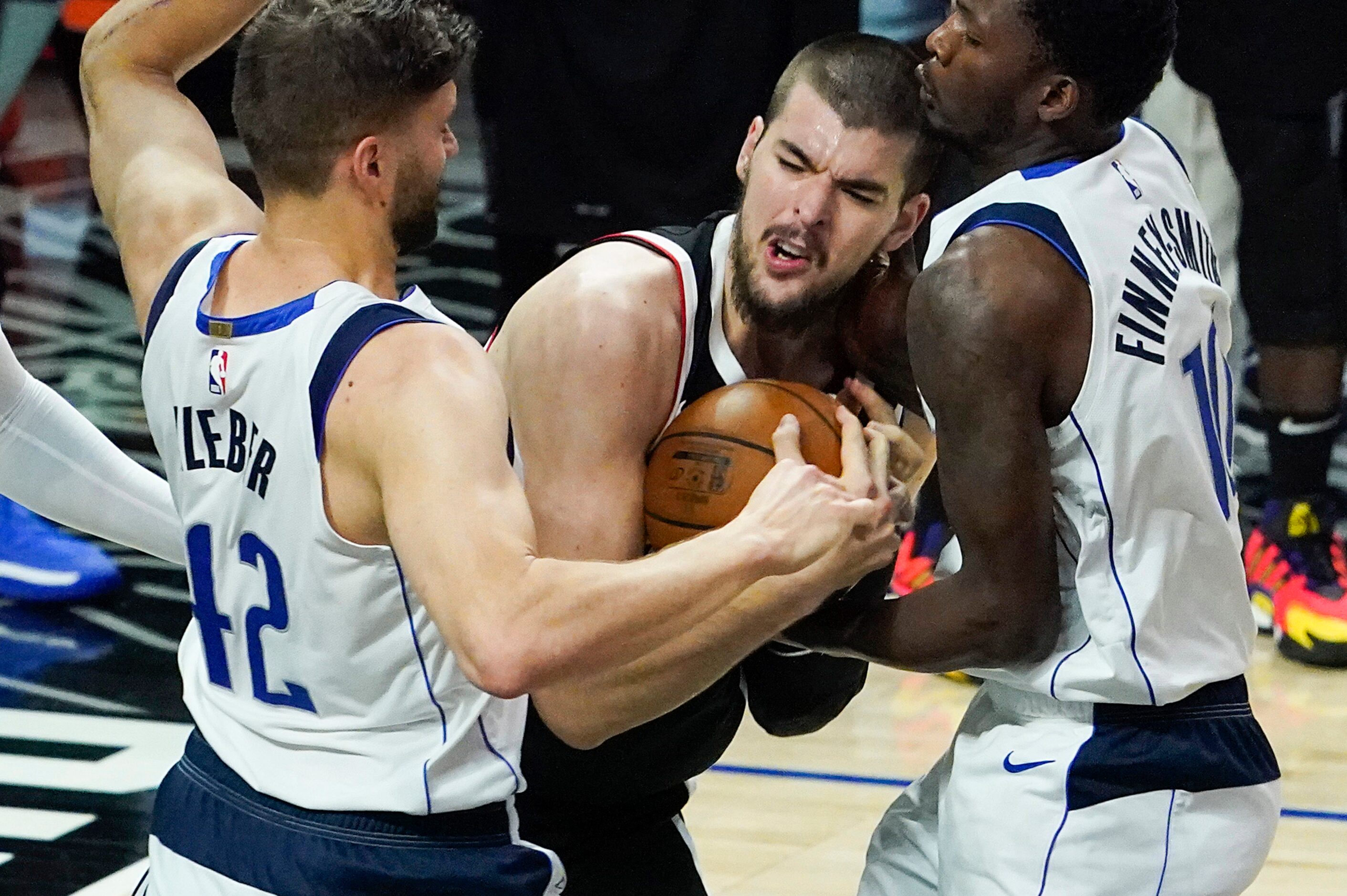 LA Clippers center Ivica Zubac (40) wrestles a rebound away from Dallas Mavericks forward...