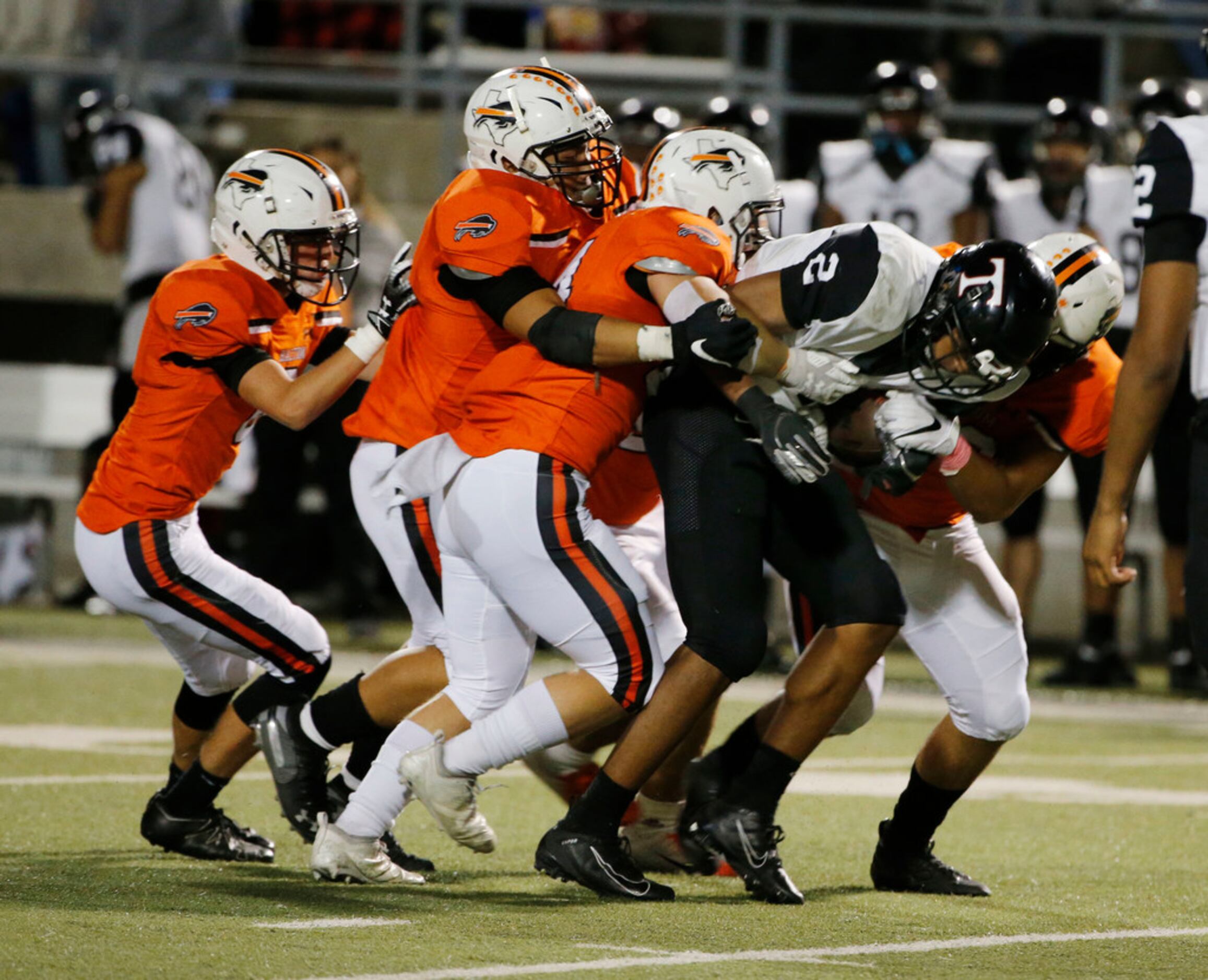 Euless Trinity running back Ollie Gordon (2) is gang tackled by Haltom defenders during the...