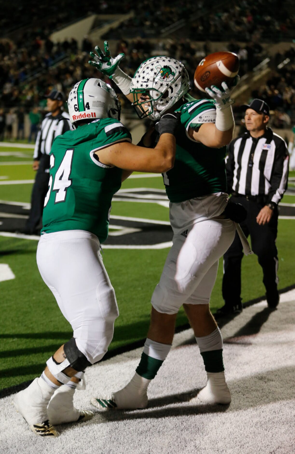 Blake Smith (11) celebrates his rushing touchdown against Eaton with Brandon Borrasso (64)...