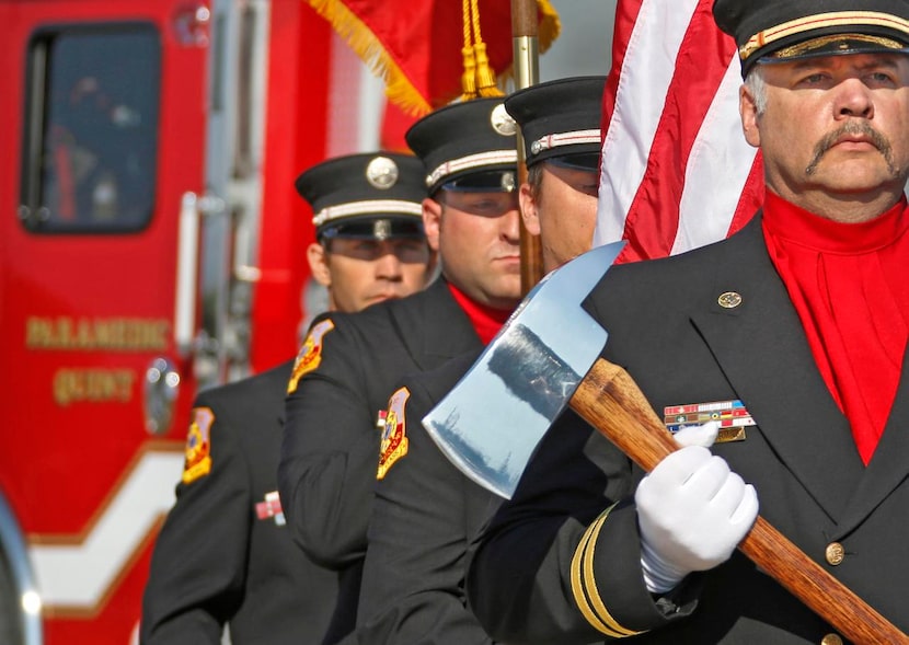 
Wylie Fire Department Capt. Matt McCormick (right) leads the color guard during ceremonies...