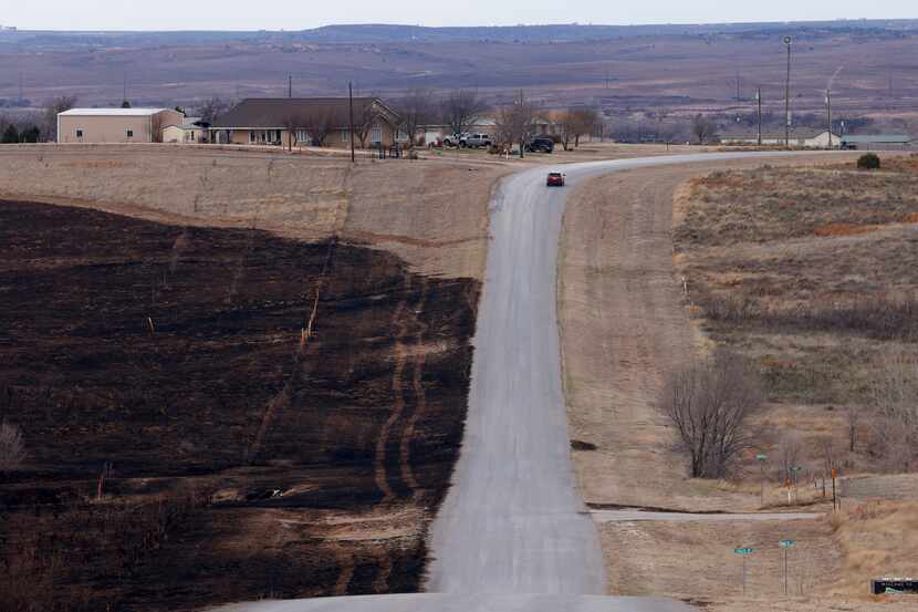 Charred grassland is seen near a road after the Smokehouse Creek Fire, Thursday, Feb. 29,...