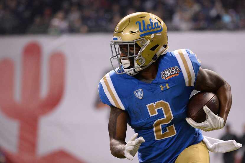 PHOENIX, AZ - DECEMBER 26: UCLA wide receiver Jordan Lasley runs the ball 52 yards to score...