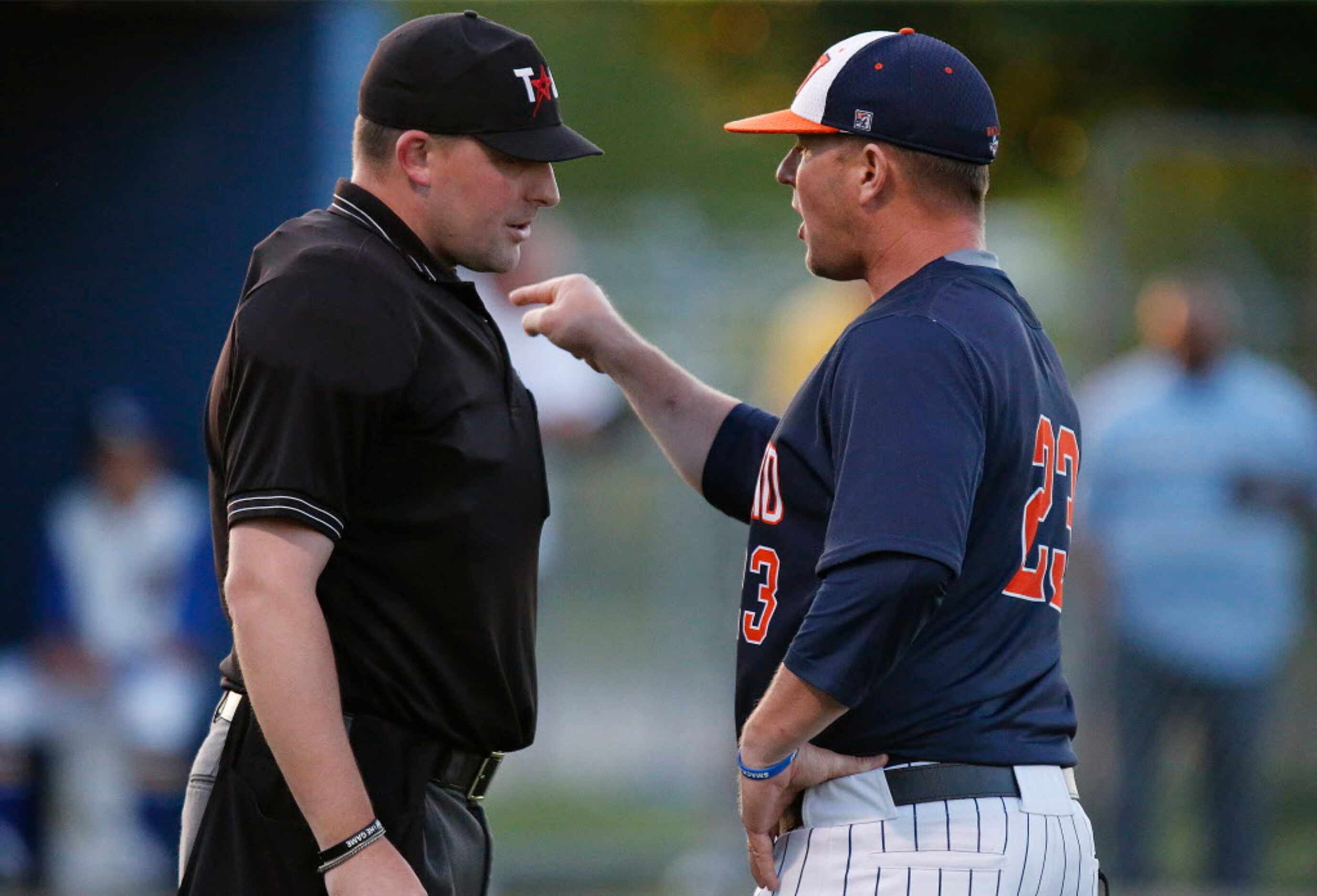 Wakeland High School head coach Barry Rose (23) argues a call by the home plate umpire as...