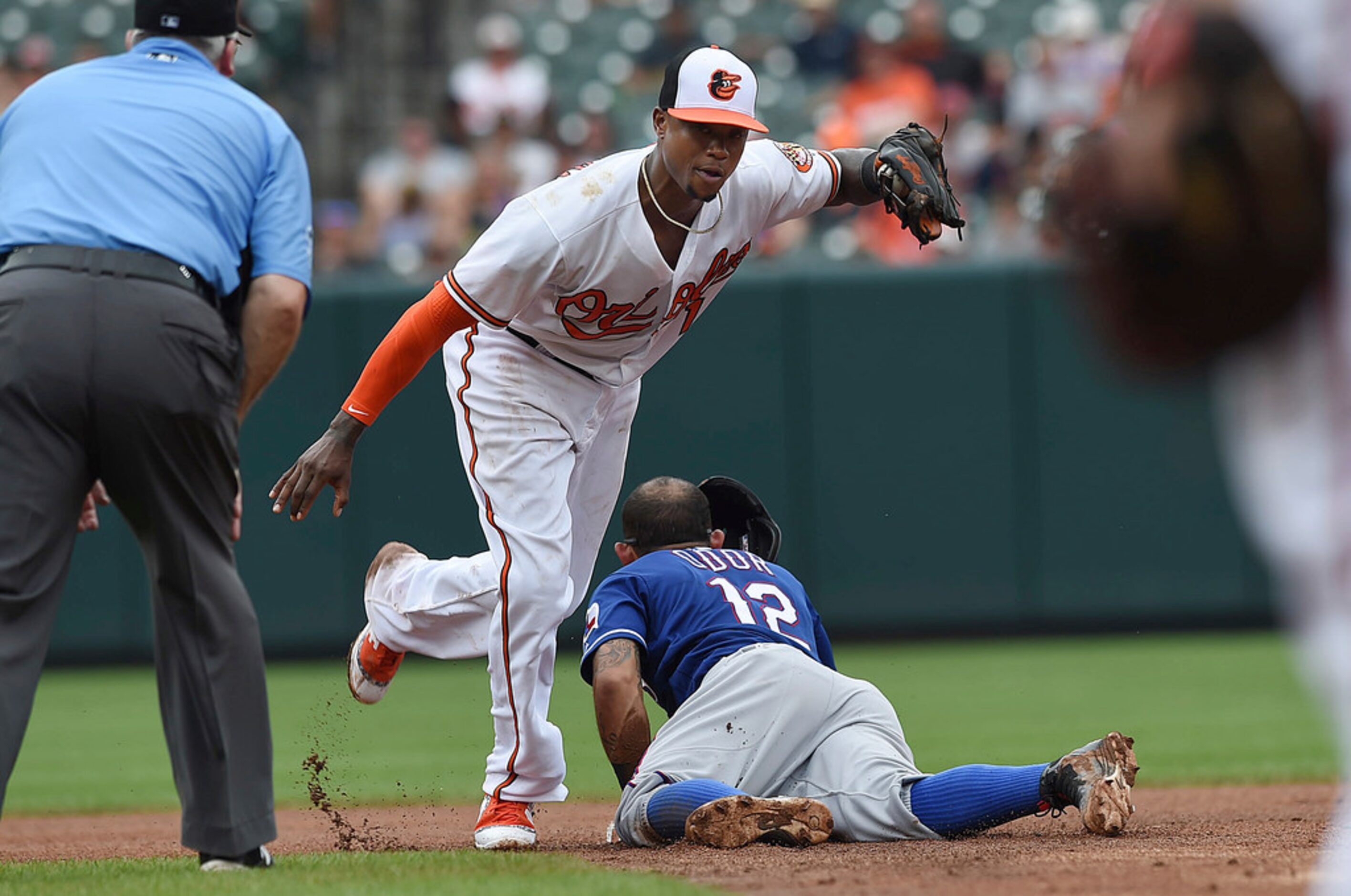 Texas Rangers' Roughned Odor (12) slides into second after being tagged out by Baltimore...