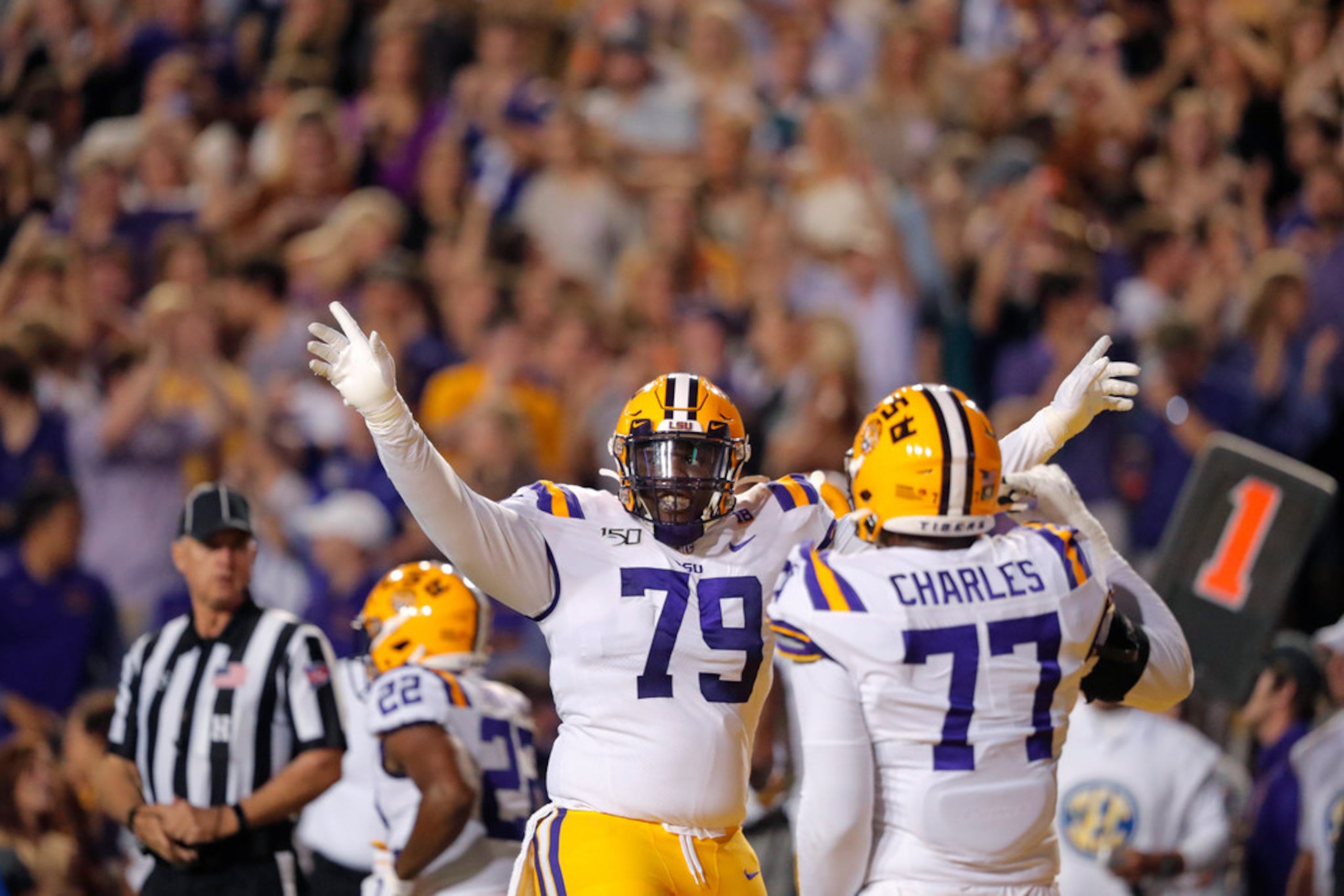 LSU center Lloyd Cushenberry III (79) and offensive tackle Saahdiq Charles (77) celebrate a...