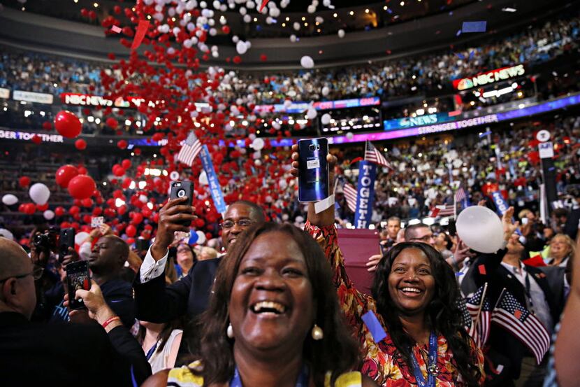 Women cheer as confetti drops at the conclusion of the  Democratic National Convention. 