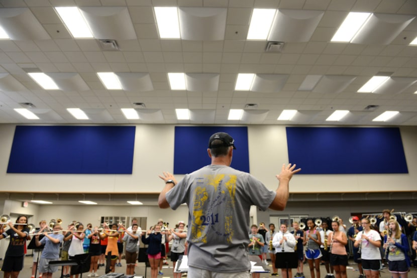 Band director Glenn Lambert conducts students during a band practice in the new band hall at...