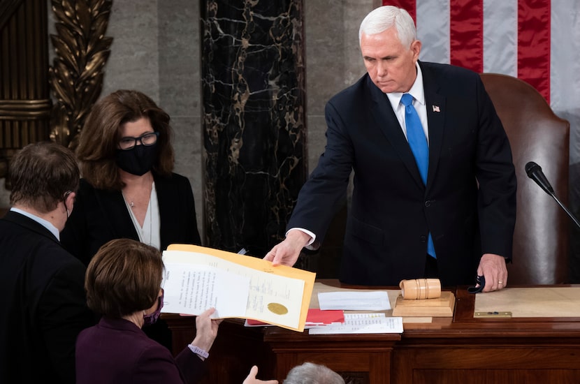 FILE - Vice President Mike Pence hands the electoral certificate from the state of Arizona...