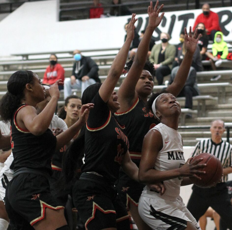 Arlington Martin's Mariah Roberts (5) contemplates her next move as she found herself...