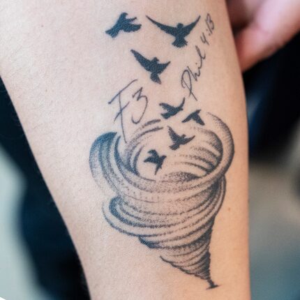 Central Market store employee Yesica Hernandez shows off her tattoo that commemorates an...