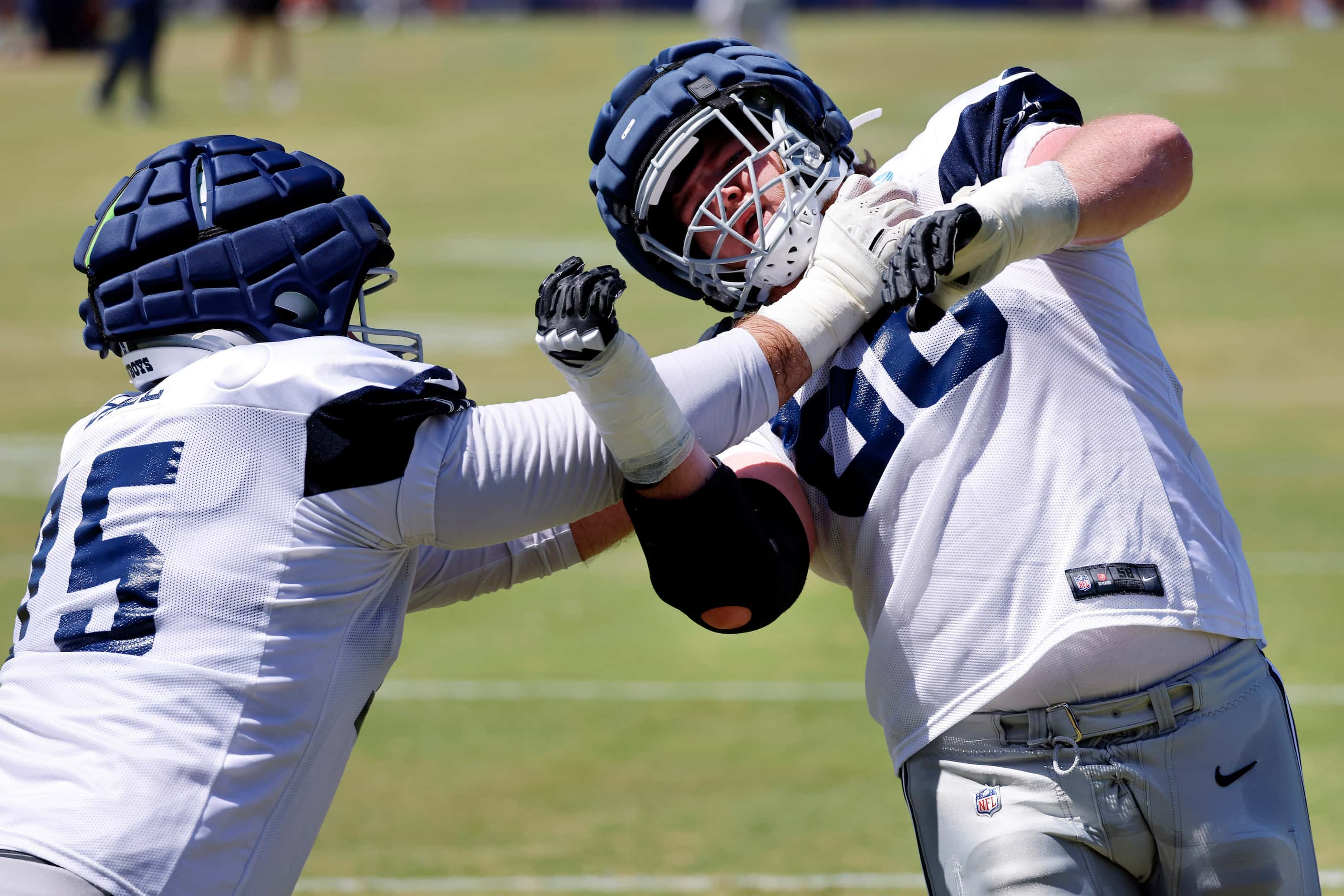 Dallas Cowboys guard T.J. Bass (66) tries to get around offensive tackle Josh Ball (75) as...