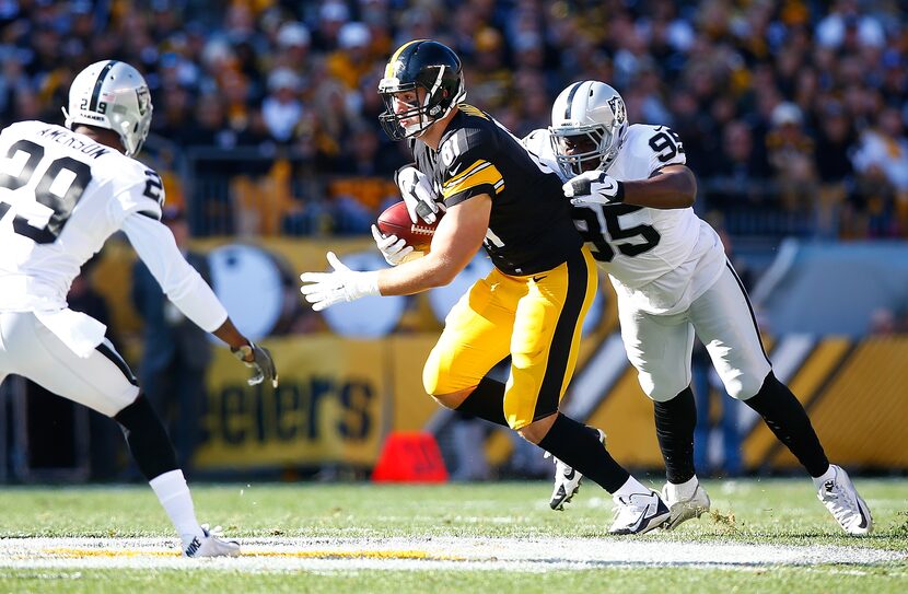 PITTSBURGH, PA - NOVEMBER 08:  Benson Mayowa #95 of the Oakland Raiders tackles Jesse James...