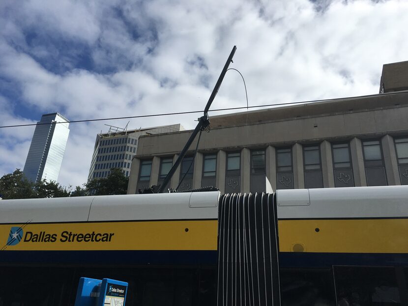 The broken pantograph, or mechanical arm that connects the car to the overhead power line.